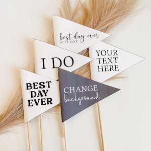 Puede incluir: Cinco banderines triangulares blancos y grises con texto negro en palos. Los banderines dicen "Best Day Ever 01.02.20XX", "I Do", "Best Day Ever", "Your Text Here" y "Change Background".