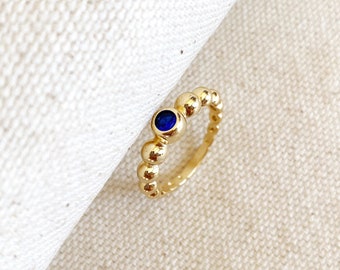 Bague en or 18 carats avec perles et zircone bleue