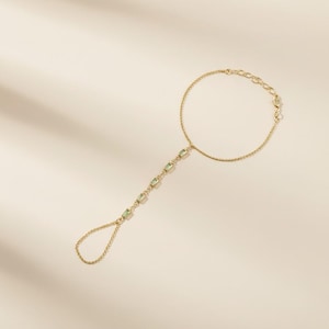 May include: A white ceramic mug with a black handle and the text "But First, Coffee" in a black, handwritten-style font. The mug is on a white surface.