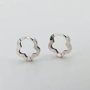 These platinum hoop earrings showcase a modern floral-inspired design, blending soft petal-like curves with a sleek geometric edge. Crafted in premium platinum, they radiate understated elegance while remaining durable for everyday wear. Lightweight and versatile, they effortlessly complement both casual and formal outfits. A refined expression of timeless style, these earrings make a graceful addition to any jewellery collection.