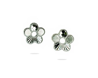 May include: A pair of silver flower-shaped earrings with a textured design.