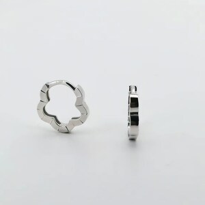These platinum hoop earrings showcase a modern floral-inspired design, blending soft petal-like curves with a sleek geometric edge. Crafted in premium platinum, they radiate understated elegance while remaining durable for everyday wear. Lightweight and versatile, they effortlessly complement both casual and formal outfits. A refined expression of timeless style, these earrings make a graceful addition to any jewellery collection.