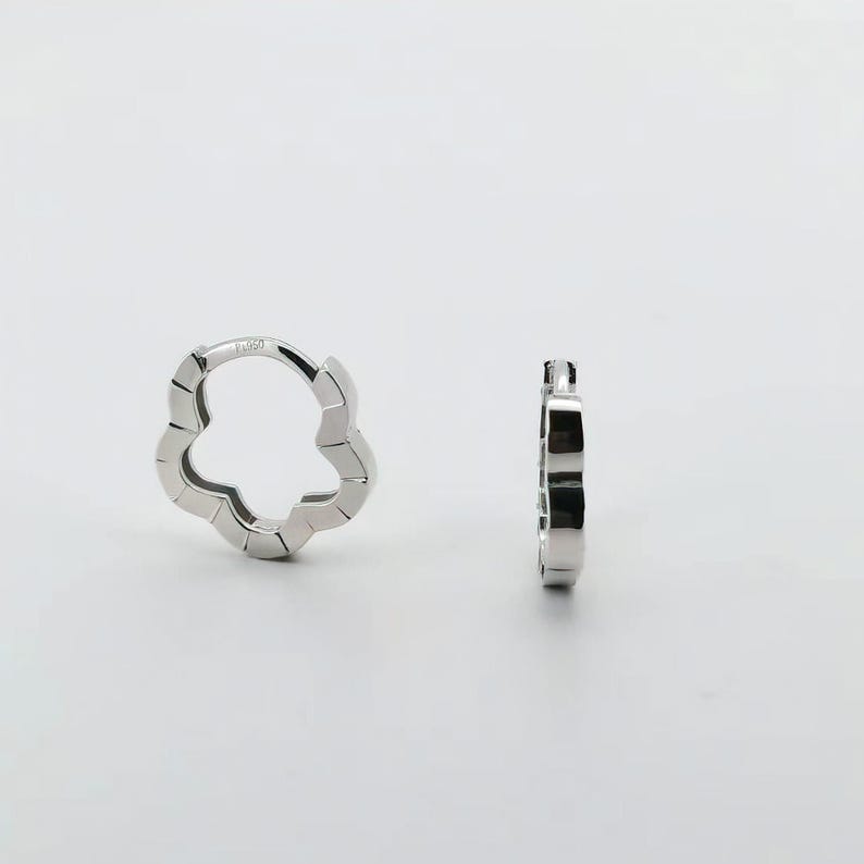 These platinum hoop earrings showcase a modern floral-inspired design, blending soft petal-like curves with a sleek geometric edge. Crafted in premium platinum, they radiate understated elegance while remaining durable for everyday wear. Lightweight and versatile, they effortlessly complement both casual and formal outfits. A refined expression of timeless style, these earrings make a graceful addition to any jewellery collection.