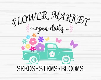 May include: A turquoise pickup truck with a bed full of colorful flowers and butterflies. The truck has the words "FLOWER MARKET open daily" above it and "SEEDS STEMS BLOOMS" below it.