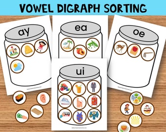 May include: A printable worksheet for sorting pictures by vowel digraphs. The worksheet features four jars with the digraphs 'ay', 'ea', 'oe', and 'ui' written on them. There are 16 pictures to sort into the jars.