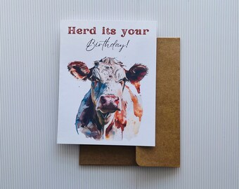 May include: A birthday card with a watercolor illustration of a cow and the text "Herd its your Birthday!"