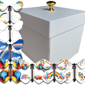 May include: White gift box with a gold knob on the lid. The box is open and contains a set of colorful butterfly pop-up cards with various birthday themes, including balloons, rainbows, and confetti.