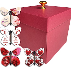May include: A burgundy gift box with a gold knob on top. Attached are several butterfly-shaped cards with messages like "To Mom," "With Love," and "I Love You." The cards feature floral and heart designs.
