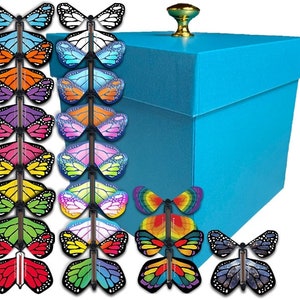 May include: A blue box with a gold knob on top. The box is surrounded by 18 colorful butterfly toys with flapping wings. The butterflies are arranged in two columns.