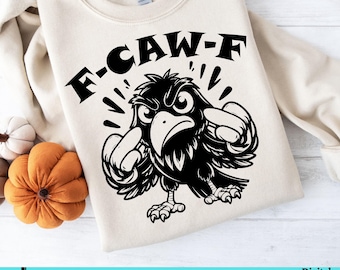 May include: Beige sweatshirt with a black graphic of an angry crow with the text "F-CAW-F". The crow is making a fist with both hands. The sweatshirt has a crew neck and long sleeves. The design is a digital download.