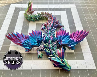 May include: A 3D printed dragon figurine with iridescent blue, green, and purple scales. The dragon is posed with its wings spread out and its head tilted to the side.