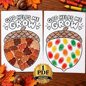 May include: Two white paper sheets featuring the text GOD HELPS ME GROW and a large acorn outline. One acorn is filled with brown and orange paper scraps, while the other features colorful red, orange, yellow, and green fingerprint art.