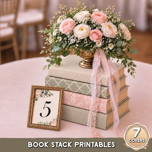 May include: A stack of four books with textured covers in beige, sage green with a white quatrefoil pattern, and dusty pink with a floral damask print. A gold vase holds a floral arrangement of pink ranunculus and greenery with a pink ribbon.