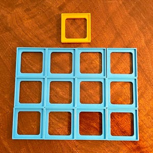 May include: A grid of 15 blue squares with a single yellow square above the grid.