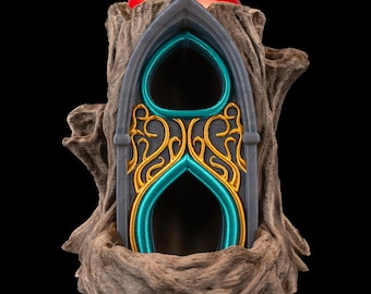 May include: A 3D-printed can cooler featuring a gothic arch design with teal and gold accents, set within a textured, tree-like base. A red can is visible at the top, suggesting its use for beverages.