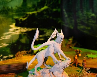 May include: A white painted miniature figurine of a creature with a cat-like body, a long tail, and two sets of wings. The creature is standing on a rock base.