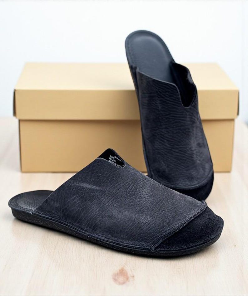 Handmade leather slip-on mules crafted in timeless black and cream colors. Made from genuine leather with a rustic, natural texture, these unisex shoes combine comfort and durability for everyday wear. Available in EU sizes 38–43, but please note: sizing runs small (example: EU 38 fits closer to EU 40). Perfect for summer outfits with jeans or shorts, they are stylish, breathable, and versatile for men and women who value artisan quality.