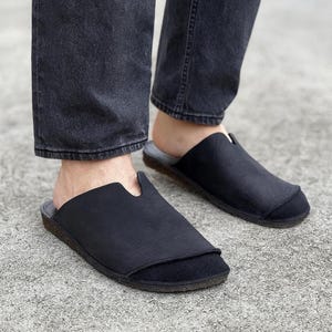 Handmade leather slip-on mules crafted in timeless black and cream colors. Made from genuine leather with a rustic, natural texture, these unisex shoes combine comfort and durability for everyday wear. Available in EU sizes 38–43, but please note: sizing runs small (example: EU 38 fits closer to EU 40). Perfect for summer outfits with jeans or shorts, they are stylish, breathable, and versatile for men and women who value artisan quality.