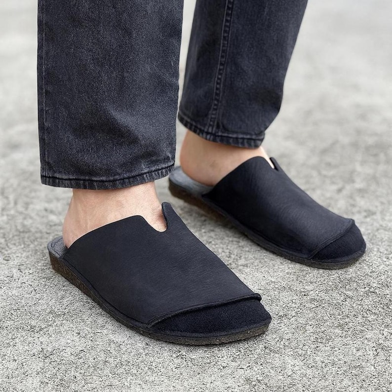 Handmade leather slip-on mules crafted in timeless black and cream colors. Made from genuine leather with a rustic, natural texture, these unisex shoes combine comfort and durability for everyday wear. Available in EU sizes 38–43, but please note: sizing runs small (example: EU 38 fits closer to EU 40). Perfect for summer outfits with jeans or shorts, they are stylish, breathable, and versatile for men and women who value artisan quality.