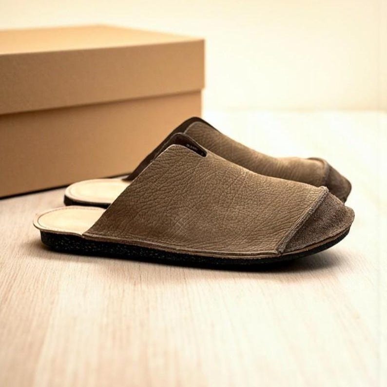 Handmade leather slip-on mules crafted in timeless black and cream colors. Made from genuine leather with a rustic, natural texture, these unisex shoes combine comfort and durability for everyday wear. Available in EU sizes 38–43, but please note: sizing runs small (example: EU 38 fits closer to EU 40). Perfect for summer outfits with jeans or shorts, they are stylish, breathable, and versatile for men and women who value artisan quality.