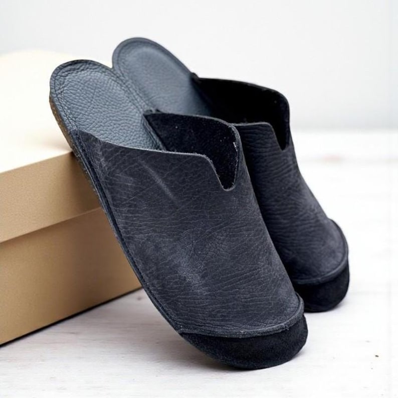Handmade leather slip-on mules crafted in timeless black and cream colors. Made from genuine leather with a rustic, natural texture, these unisex shoes combine comfort and durability for everyday wear. Available in EU sizes 38–43, but please note: sizing runs small (example: EU 38 fits closer to EU 40). Perfect for summer outfits with jeans or shorts, they are stylish, breathable, and versatile for men and women who value artisan quality.