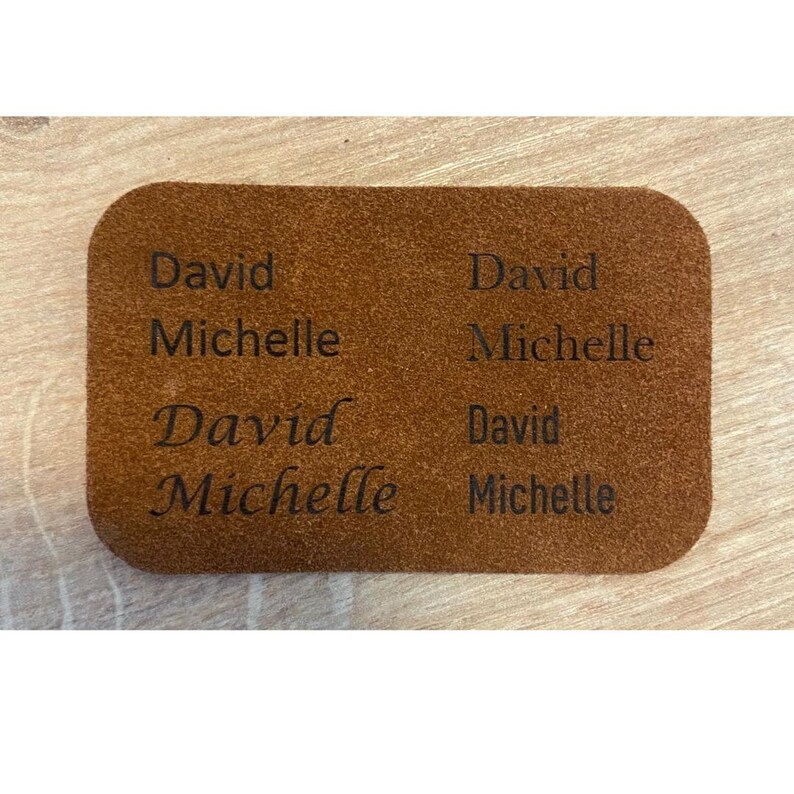 Handmade green suede leather wallet with soft texture and snap button closure, shown being held by hand. The wallet has a minimalist, long clutch design ideal for carrying cards, cash, or small essentials. Styled with a clean white wood background and green succulents, highlighting the natural and elegant feel of the product. A perfect choice for daily use or casual minimalist fashion lovers.