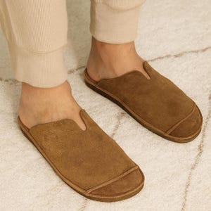Handmade leather slip-on mules crafted in timeless black and cream colors. Made from genuine leather with a rustic, natural texture, these unisex shoes combine comfort and durability for everyday wear. Available in EU sizes 38–43, but please note: sizing runs small (example: EU 38 fits closer to EU 40). Perfect for summer outfits with jeans or shorts, they are stylish, breathable, and versatile for men and women who value artisan quality.