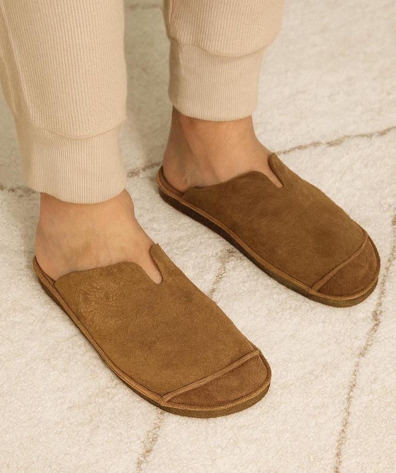 Handmade leather slip-on mules crafted in timeless black and cream colors. Made from genuine leather with a rustic, natural texture, these unisex shoes combine comfort and durability for everyday wear. Available in EU sizes 38–43, but please note: sizing runs small (example: EU 38 fits closer to EU 40). Perfect for summer outfits with jeans or shorts, they are stylish, breathable, and versatile for men and women who value artisan quality.