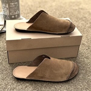 Handmade leather slip-on mules crafted in timeless black and cream colors. Made from genuine leather with a rustic, natural texture, these unisex shoes combine comfort and durability for everyday wear. Available in EU sizes 38–43, but please note: sizing runs small (example: EU 38 fits closer to EU 40). Perfect for summer outfits with jeans or shorts, they are stylish, breathable, and versatile for men and women who value artisan quality.