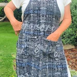 Apron with pockets in front, made from upcycled, handwoven Guatemalan corte fabric. Gray/White, with light blue accents. Sizes S & M