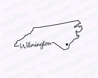 May include: A black and white line drawing of the state of North Carolina with the city of Wilmington labeled and a small heart marking a location within the state.