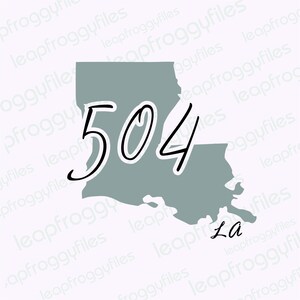 May include: A grey outline of the state of Louisiana with the area code 504 written in black cursive script. The text "La" is written in black cursive script below the state outline.