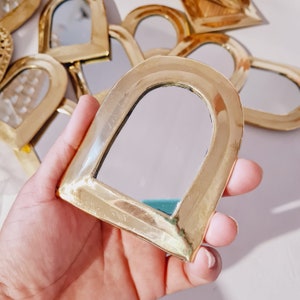 Small golden brass wall mirror