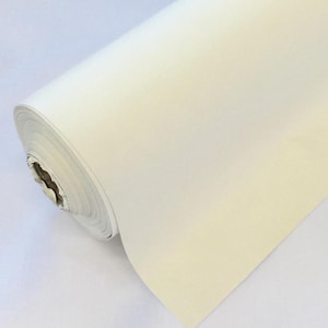 May include: A roll of white fabric, likely for crafting or sewing projects.