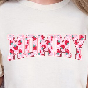 Strawberry-themed retro varsity style Mother's Day PNG shirt designs for sublimation, featuring Mama, Momma, Mini, Gigi, Gram, and Lita in pink red floral fruit print on white t-shirts, digital files for Cricut and heat press crafting, perfect for Mother's Day gifts and matching family outfits on Etsy.