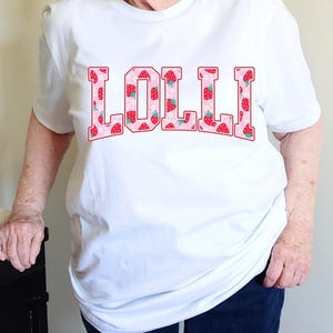 Strawberry-themed retro varsity style Mother's Day PNG shirt designs for sublimation, featuring Mama, Momma, Mini, Gigi, Gram, and Lita in pink red floral fruit print on white t-shirts, digital files for Cricut and heat press crafting, perfect for Mother's Day gifts and matching family outfits on Etsy.
