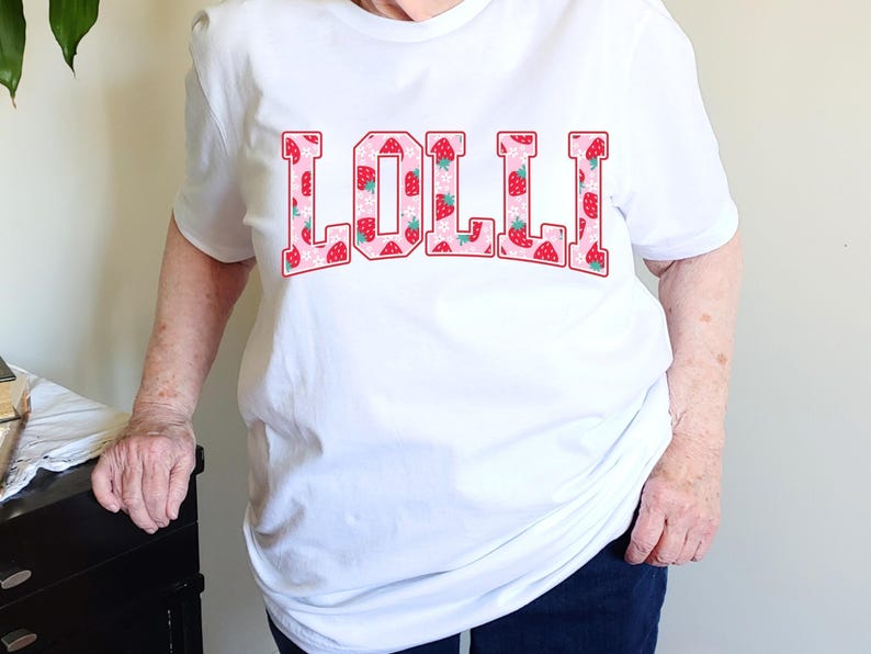 Strawberry-themed retro varsity style Mother's Day PNG shirt designs for sublimation, featuring Mama, Momma, Mini, Gigi, Gram, and Lita in pink red floral fruit print on white t-shirts, digital files for Cricut and heat press crafting, perfect for Mother's Day gifts and matching family outfits on Etsy.