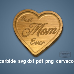 May include: A wooden heart-shaped plaque with the text "Best Mom Ever" engraved on it. The plaque has a light brown wood grain and a slightly raised edge.
