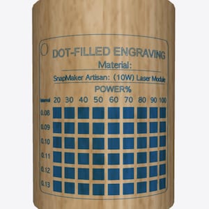 May include: A brown paper chart with the title "DOT-FILLED ENGRAVING" and the text "Material: SnapMaker Artisan: (10W) Laser Module POWER%". The chart has a grid of squares with different shades of blue, representing different power levels for laser engraving.
