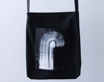 Black canvas tote bag with vegan leather pocket