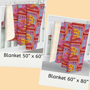 May include: Two fleece blankets with a retro design featuring a repeated pattern of red, yellow, and blue sardine cans. The text on the cans reads "Sardines in Extra Virgin Olive Oil". The blanket on the left is 50 inches by 60 inches. The blanket on the right is 60 inches by 80 inches.