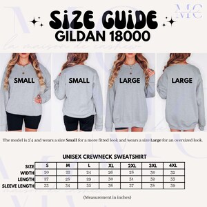 May include: Size chart for Gildan 18000 unisex crewneck sweatshirts. The chart shows measurements in inches for width, length, and sleeve length for sizes S, M, L, XL, 2XL, 3XL, and 4XL.