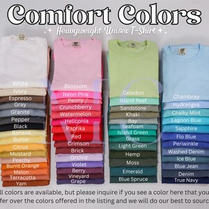 May include: Image of stacks of Comfort Colors heavyweight unisex t-shirts in various colors, including white, pink, green, and blue. Each stack displays a different color, with a list of available shades below each stack. The text "Comfort Colors" is at the top.