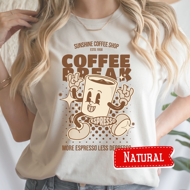May include: A white t-shirt with a brown cartoon coffee cup graphic. The text on the shirt reads "Sunshine Coffee Shop Est. 1958 Coffee Break Espresso More Espresso Less Depresso" and "Natural".
