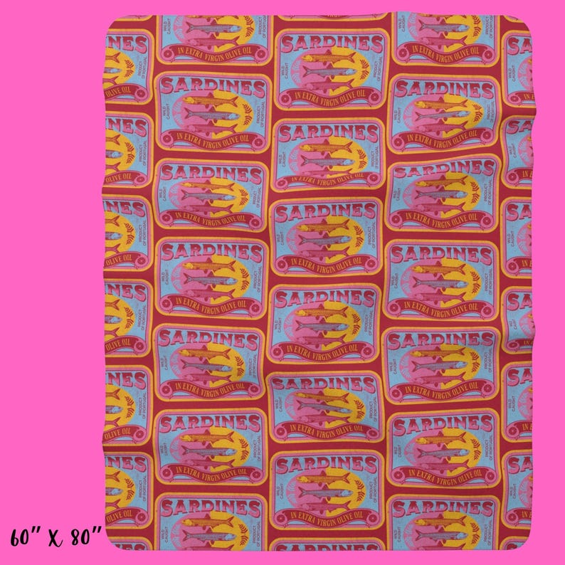 May include: A red and blue patterned fabric with a repeating design of sardine cans. Each can has a yellow label with the text "SARDINES IN EXTRA VIRGIN OLIVE OIL" and a picture of three sardines. The fabric is 60 inches by 80 inches.