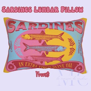 May include: A lumbar pillow shaped like a can of sardines. The pillow is yellow, pink, and blue with the words "Sardines" and "In Extra Virgin Olive Oil" printed on it. The pillow is a fun and quirky way to add a touch of personality to your home.