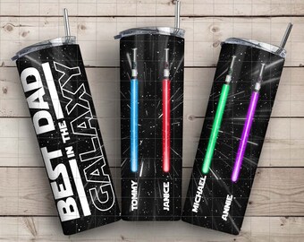 May include: Three black and white stainless steel tumblers with a galaxy print and the text "Best Dad in the Galaxy". Each tumbler has a different colored lightsaber graphic with the names "Tommy", "Janice", and "Annie" printed on the bottom.