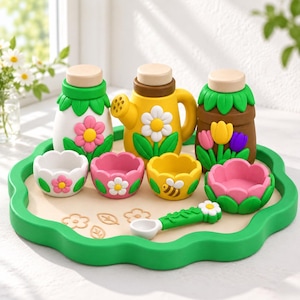 May include: A set of three containers with wooden lids, four flower-shaped bowls, and a small spoon on a green scalloped tray. The items feature colourful floral designs, including pink, yellow, and purple tulips, daisies, and a small bee graphic.