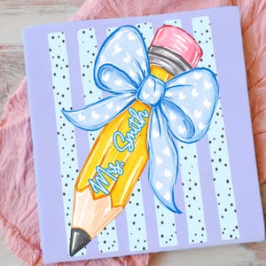 May include: A light purple notebook with a pencil illustration. The yellow pencil has a pink eraser and a blue bow with white hearts. The text "Ms. Smith" is written on the pencil in blue script. The background has vertical stripes and black polka dots.
