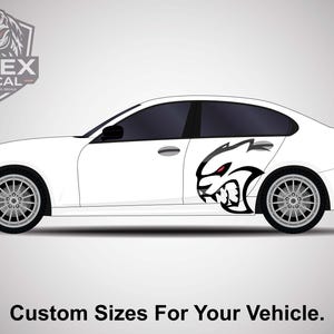 May include: A white car with a black and red graphic of a snarling animal on the side. The car has black tinted windows and silver rims. The text "Custom Sizes For Your Vehicle" is at the bottom of the image.
